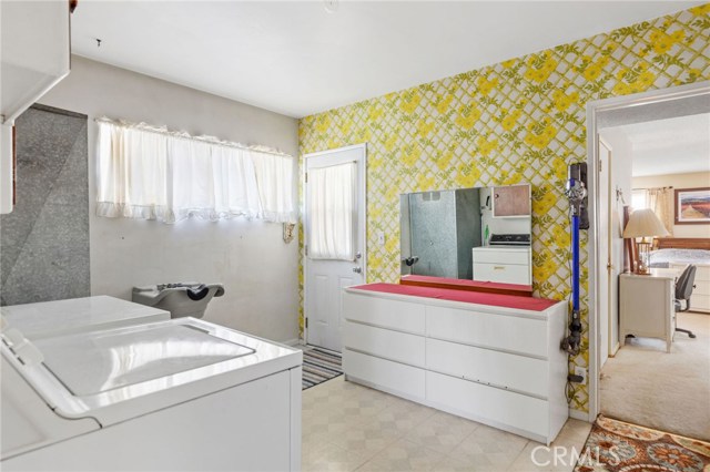 Giant utility room and door to driveway and garage. Large en-suite bedroom through door.