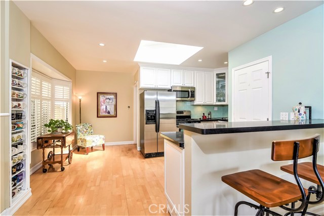 The dining area is surrounded by windows, a skylight and canned lighting which make this a bright and sunny area