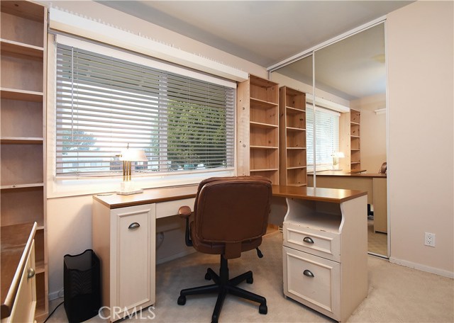 Bedroom #2 with mirrored closet doors currently used as an office