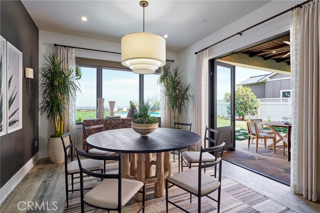 Dining room opens onto the covered patio and backyard. Model home shown, same floorplan.