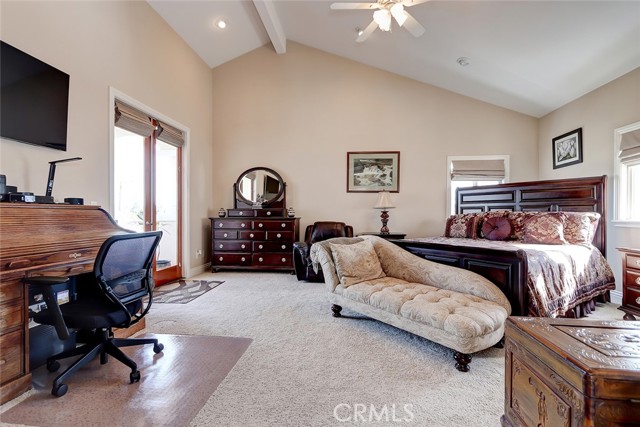 Large master bedroom with vaulted ceilings, featuring a balcony and view to the north and east of snow covered mountains!  So beautiful on a clear day!