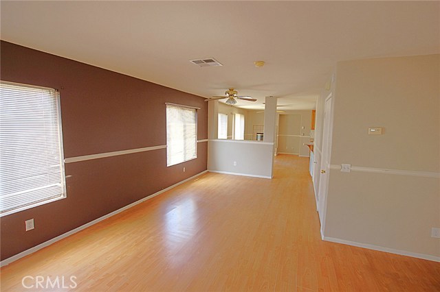 View from the Living of the Dining Room with Fireplace. The Kitchen is around the corner to the right. Laminate Floors and Tons of Living Space.