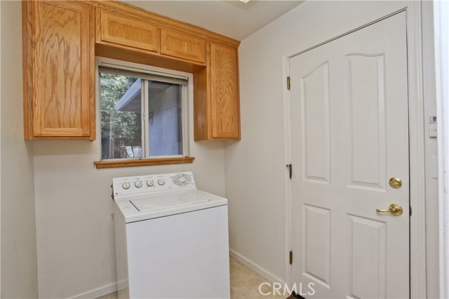 Laundry room with cupboards for storage