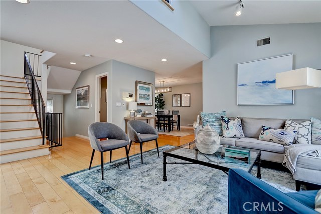 Maple hardwood floors and recessed lighting throughout.