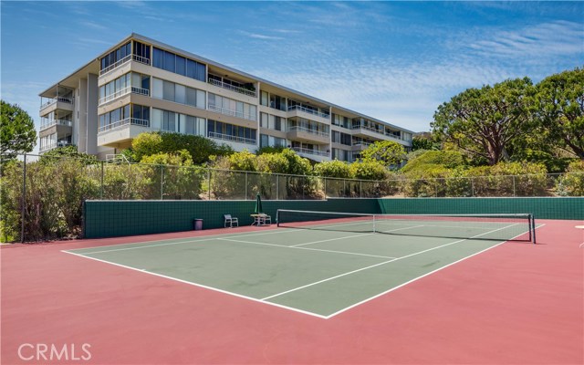 A photo of the upper tennis court.  The courts were recently re-covered and now sport a blue court.  This is a photo of Building 9.