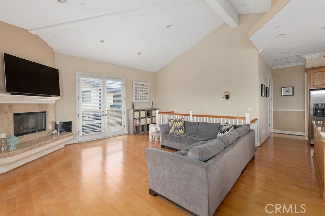 Versatile, open floor place with beautiful corner fireplace and french doors leading comfortabe outdoor space
