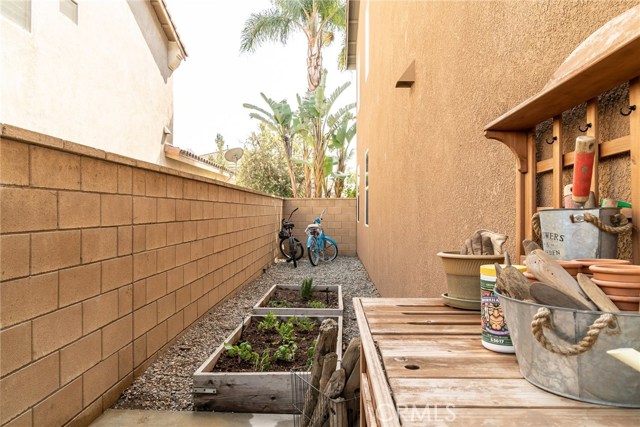 Raised herb garden beds on side of house