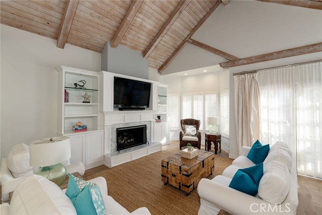living room with fireplace and built in cabinets & shelves