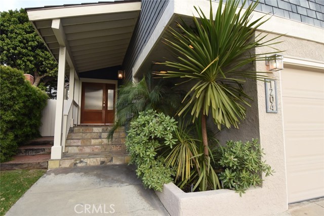 Beautiful slate entrance and glass accented front door.