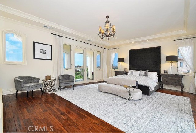 Spacious master bedroom with two balconies that looks out on ocean views