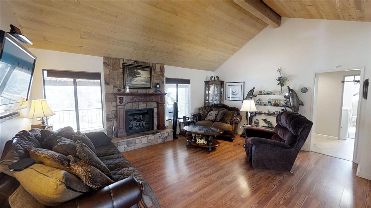 Living Room Enjoys Wonderful Views and Vaulted Wood Beamed Ceilings!