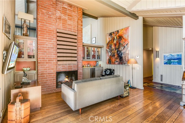 Den/game room with wet bar and fireplace