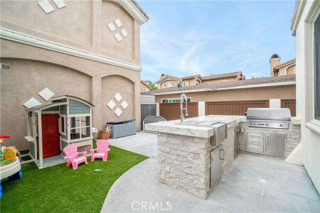 Backyard BBQ area and patio, entry to family room on the right side
