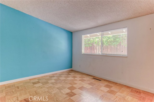 3rd bedroom with window looking towards gated sideyard