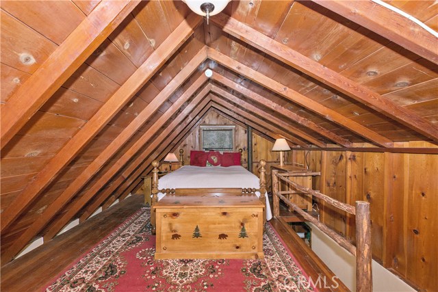 Upstairs loft-style bedroom.  Check out all that beautiful woodwork!