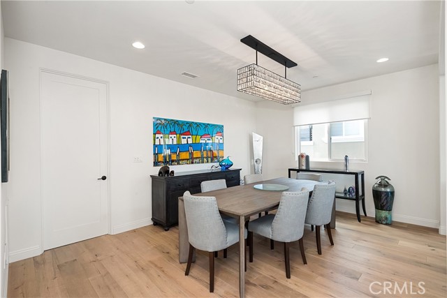 Huge dining area with designer lighting and custom window covering