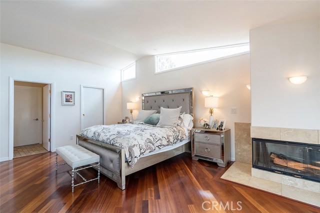 Master bedroom with fireplace and solid cherry floors