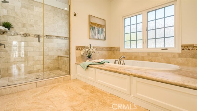 Master bathroom with large shower and bench seat.Jetted tub to soak and relax in.