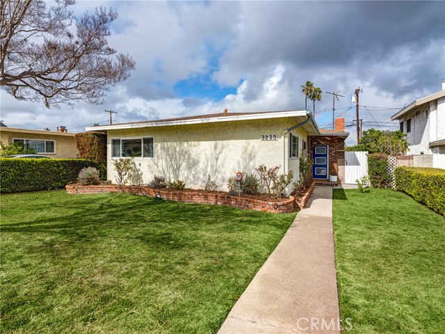 Well maintained front yard provides great curb appeal and privacy.