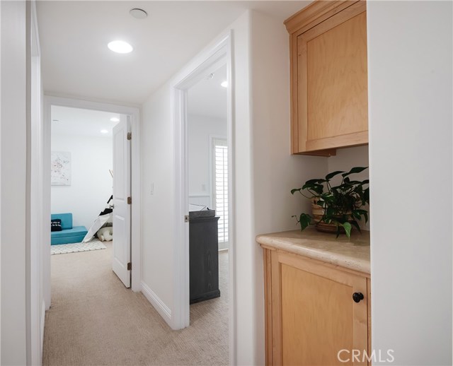 Upper hallway from primary bedroom to additional bedrooms, more linen cabinets and hall bathroom.