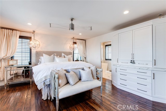 The master bath features a built in wardrobe, plantation shutters, fireplace, walk in closet, and spa-like master bath
