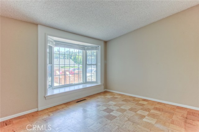 2nd Bedroom with bay window looking towards gated front patio