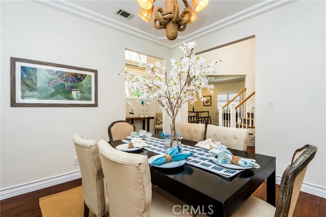 Dining room opens to front entry, flooded with natural light from 2 story ceilings.