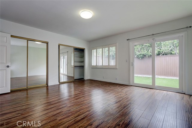 Second bedroom with hardwood floors, ample closets located downstairs