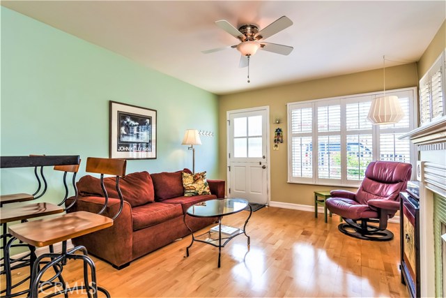 The open living room is surrounded by bright windows that flood the area with light.