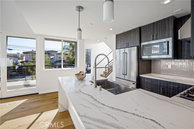 Kitchen with quartz countertops, stainless appliances