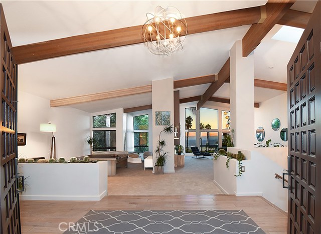 High ceilings with beautiful beams welcome you.