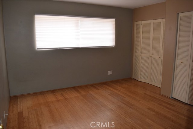 Large second bedroom with wall of closets