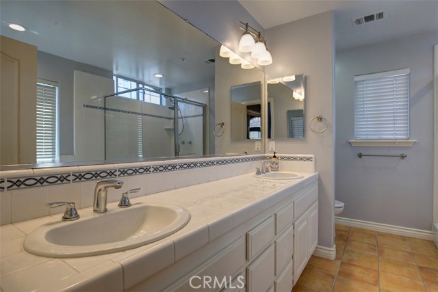 Master bath with twin sinks, separate tub and shower