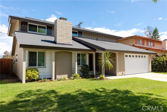 The large front yard is beautifully landscaped and a large driveway in front of the 2 car garage provides ample parking.