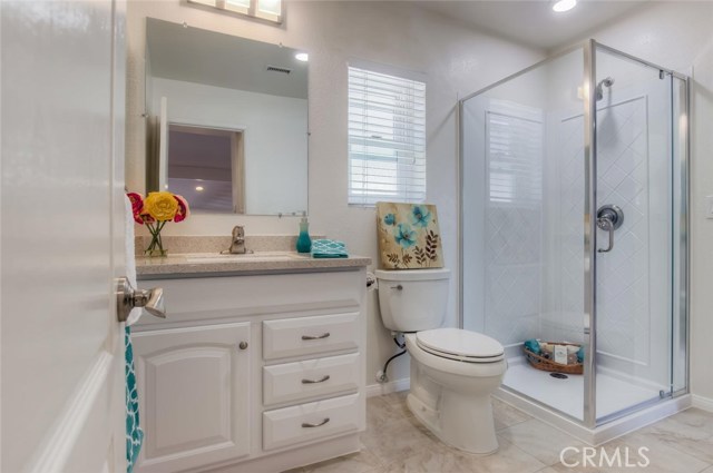This newly remodeled bath adjacent to the master features a new vanity, new shower and tile flooring.