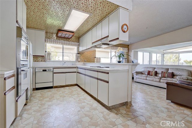 LOOKING FROM THE EAST INTO THE KITCHEN, AND DINING/FAMILY ROOMS