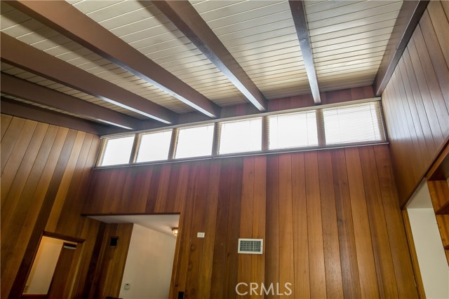 This is another view of the slopped vaulted beamed ceiling, the wooden paneled walls and the bright clerestory upper windows.