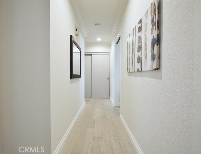 View of the bedroom hallway. Pocket door at entrance to the living area off to the right side. Notice the large hall closet.