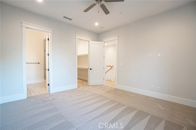 View of bedroom 3 facing hallway. View of private bathroom, walk-in closet on left hand side.