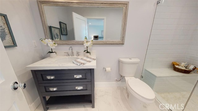 Ensuite bathroom for the 1st bedroom has a large walkin shower, contemporary sink/cabinet. you must see the shower and room floor for yourself to understand the level of detail and design