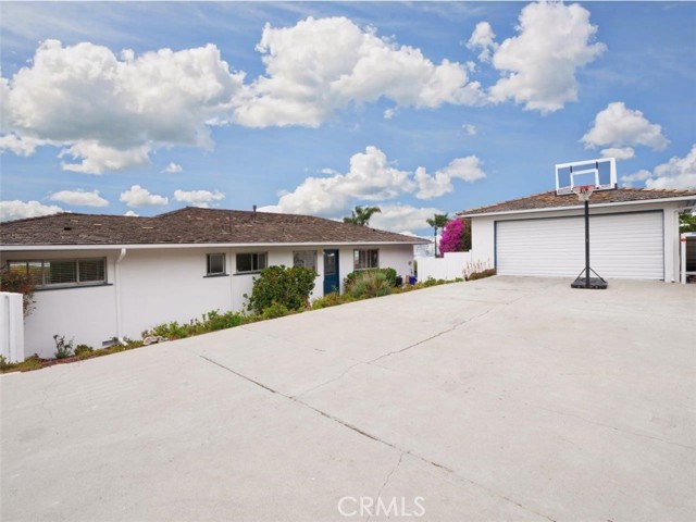 Large driveway offers plenty of space for basketball, tricycles and parking