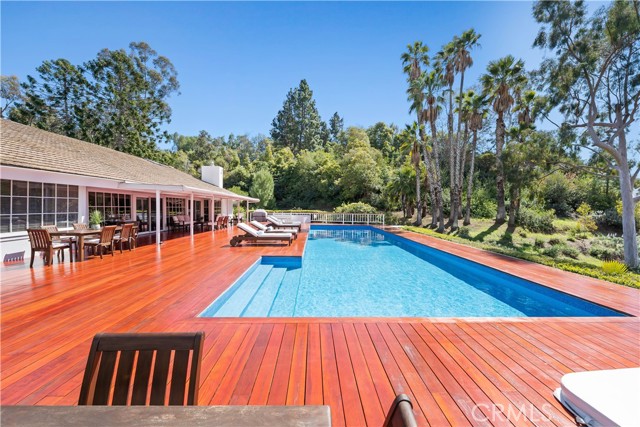 view of lap pool deck and trees