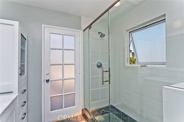 Large, walk in shower, soaking tub and access to the upper level balcony.