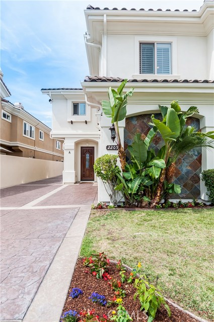 The front yard features beautiful greenery.