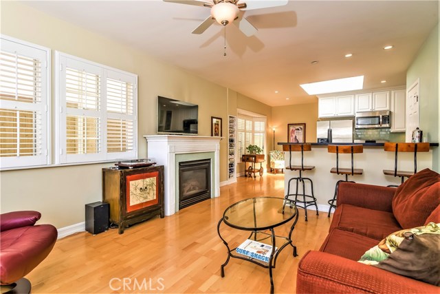 The living room has a heatilator fireplace with a wood casement surround, mantle and custom glass tile trim.