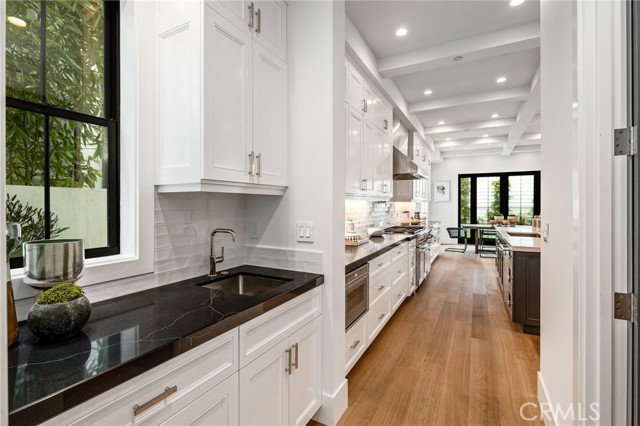 Butler's pantry and walk in storage keeps the entertaining flowing smoothing through the carefully composed floor plan.