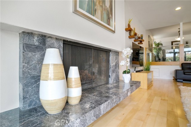 Fireplace warms the room and features a natural stone hearth