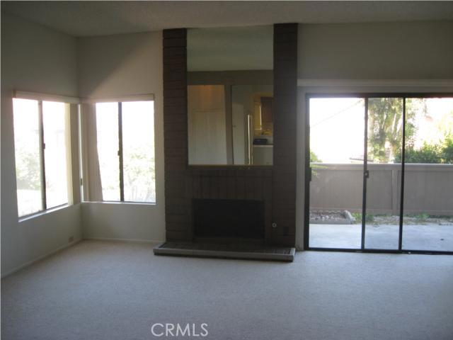Living room with fireplace and sliding doors out to private patio