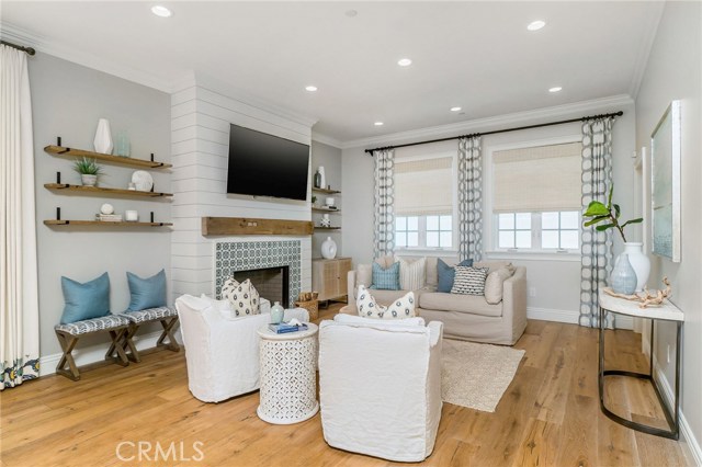 Simple yet elegant family room, with high ceilings, shiplap, custom mexican tiled fireplace and wide plank oak floors.