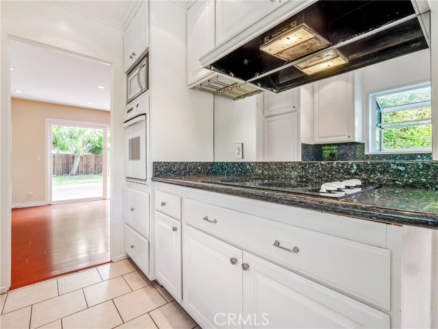 The kitchen offers clean and stylish white cabinetry, granite counter tops, with an ample sized breakfast nook.